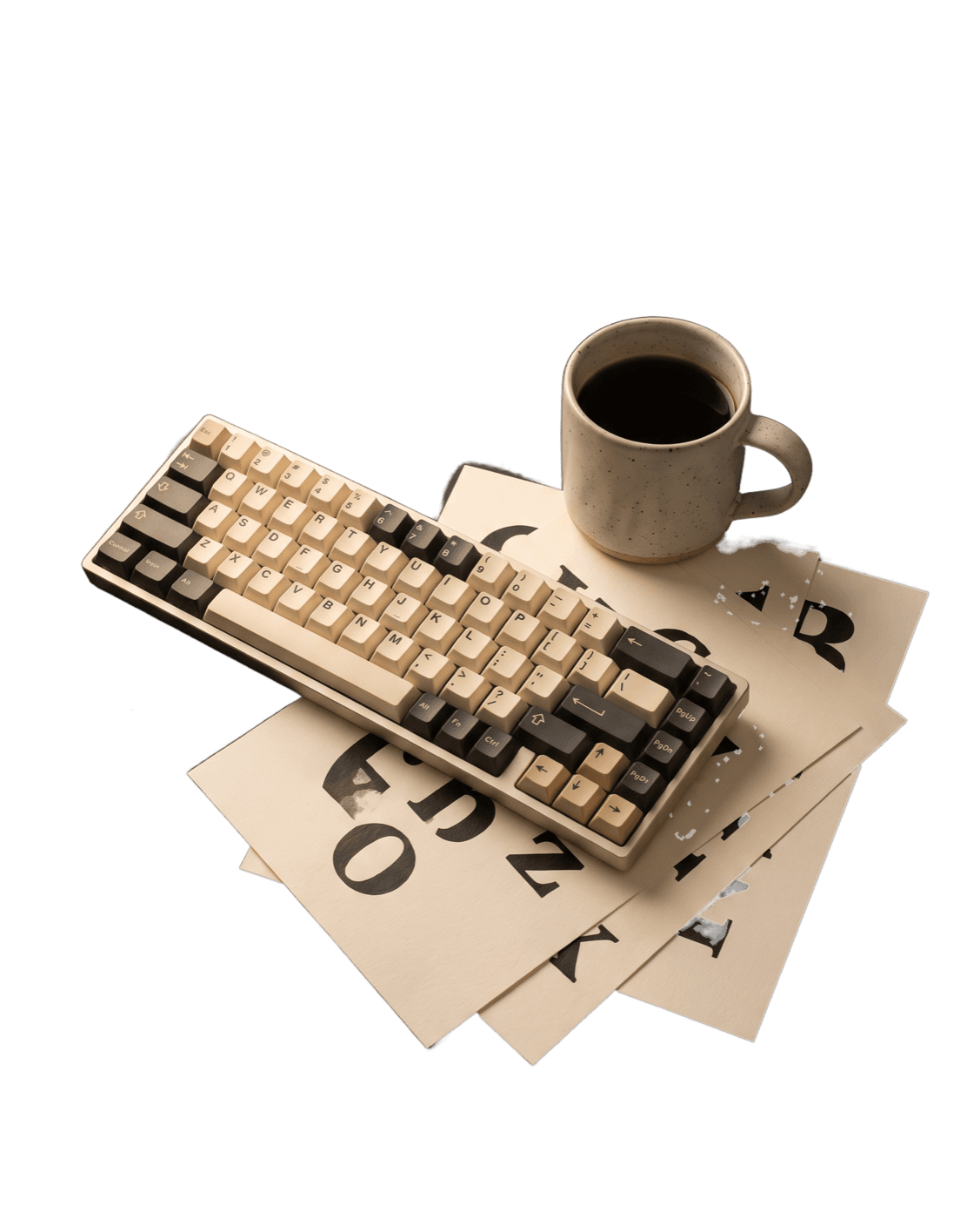 A designer's desk with a keyboard, coffee, and printed type specimens